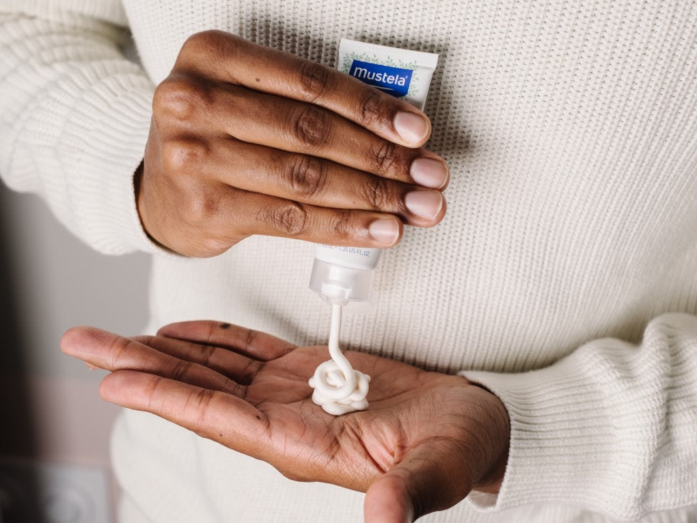 Mustela Cold Cream, cream squeezed from the tube into a palm