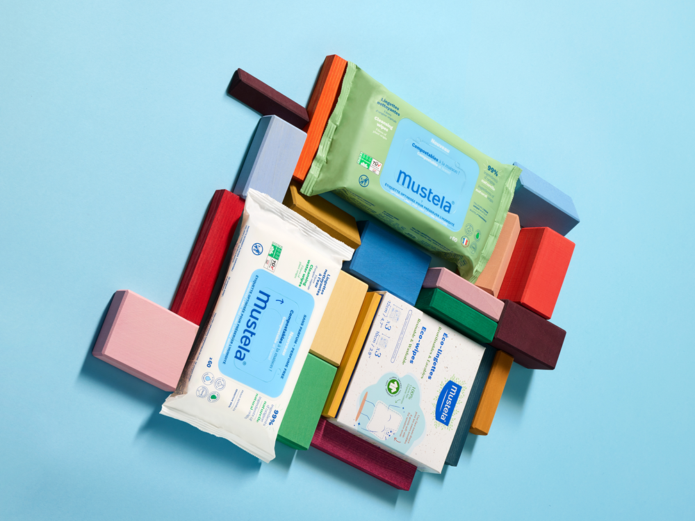 Mustela Compostable Wipes, three wipe packs among colorful wooden blocks