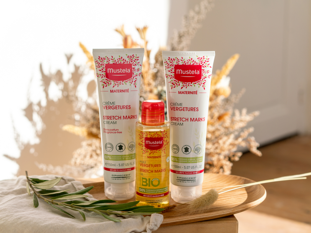 Mustela Maternity, two tubes and the oil bottle on a wooden tray