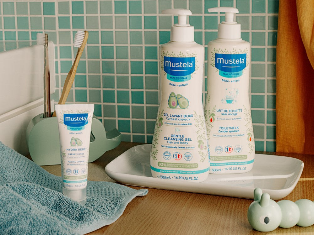 Mustela No-Rinse Cleansing Milk, range of three products on a bathroom tray
