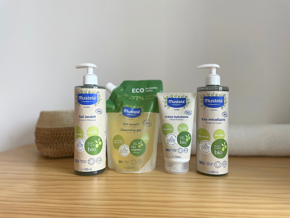 Mustela Organic Moisturizing Cream, range of four products on a wooden shelf