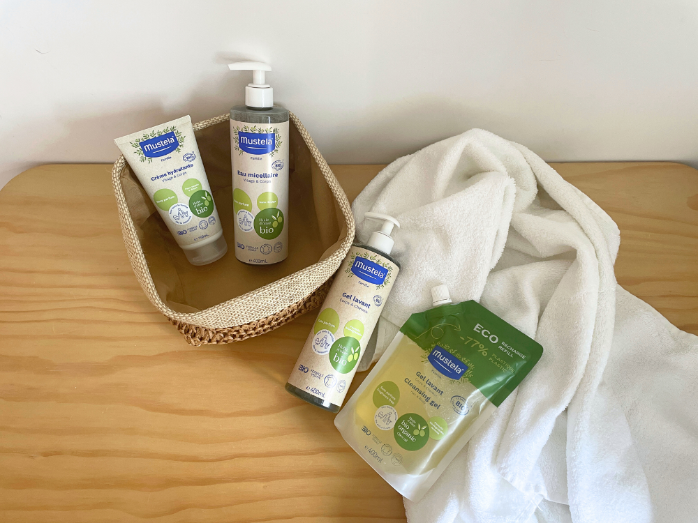 Mustela Organic Body and Hair Wash, range in a wicker basket with a refill pouch and towel