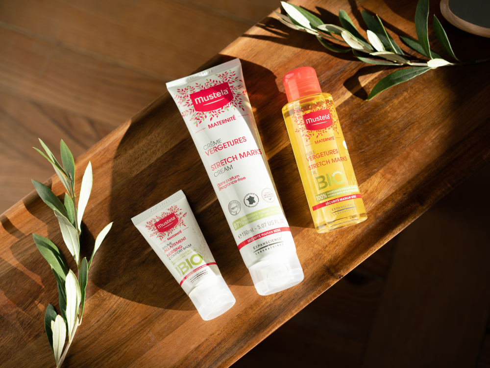 Mustela Maternity, range of three products on a wooden board