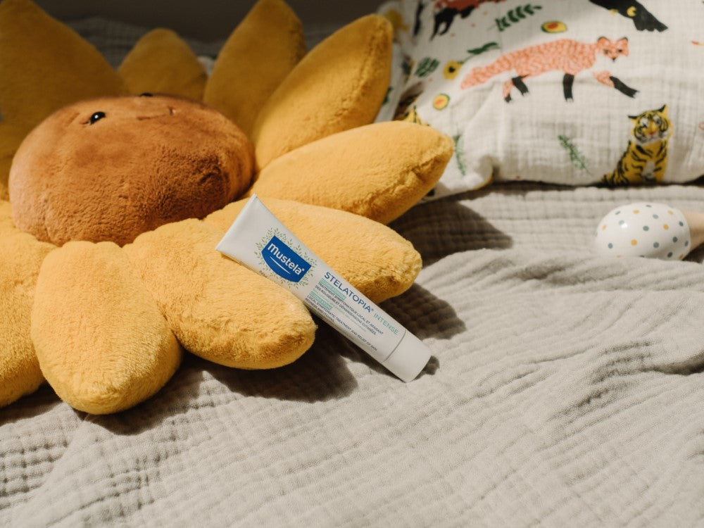 Mustela Stelatopia Intense, tube on a plush sunflower toy