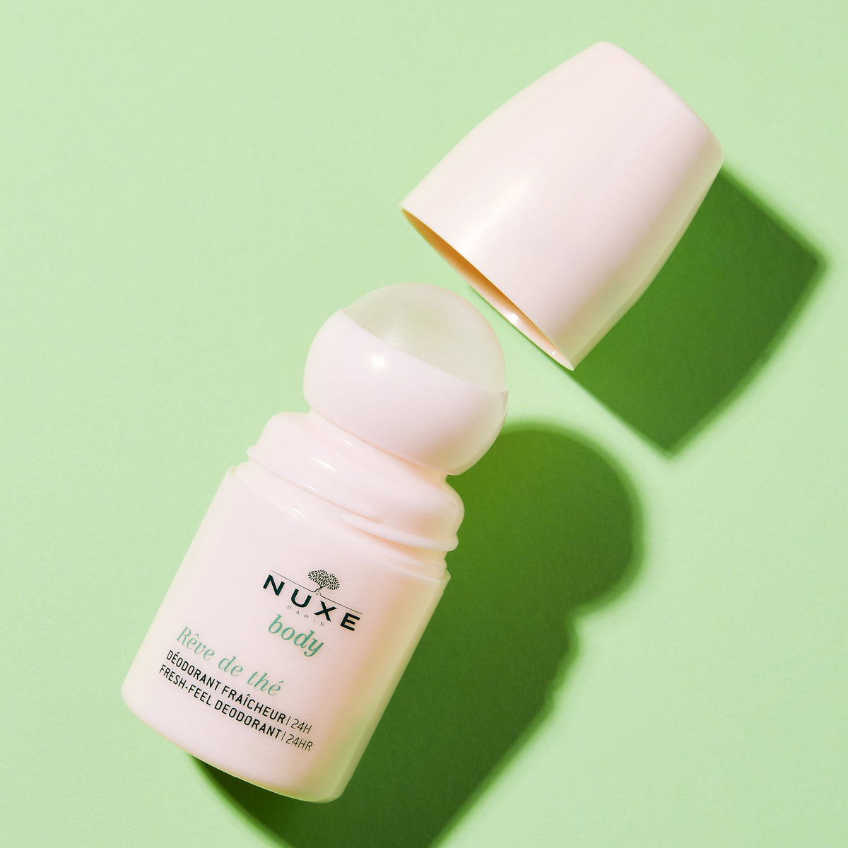 NUXE Rêve de Thé, roll-on with the cap off on a green background