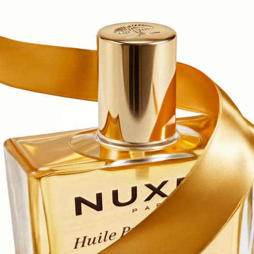 NUXE The Iconics, dry oil bottle neck and cap wrapped in a ribbon