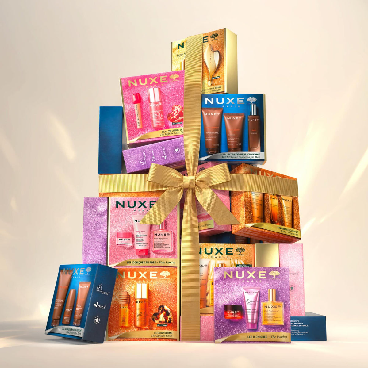 NUXE The Iconics, tower of NUXE gift sets tied with a gold bow