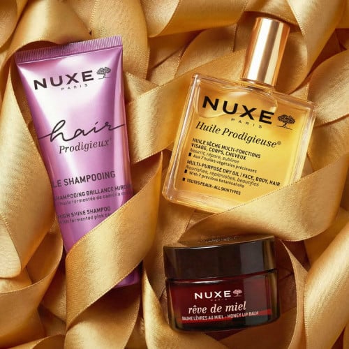 NUXE The Iconics, tube, bottle and jar nestled in gold satin