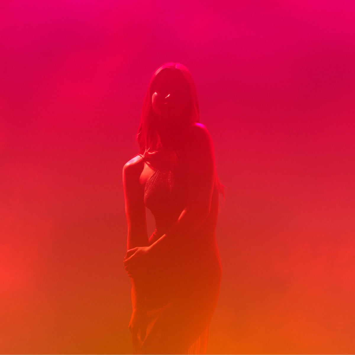 NUXE Happy In Pink, silhouette of a woman in a pink and red haze