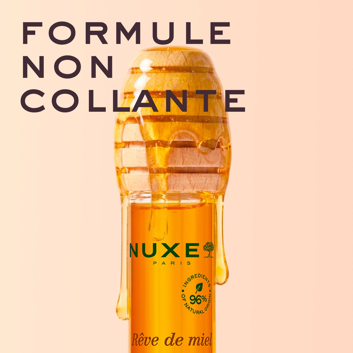 NUXE Honey Lip Balm, honey dripping from the dipper cap over the bottle, text in French