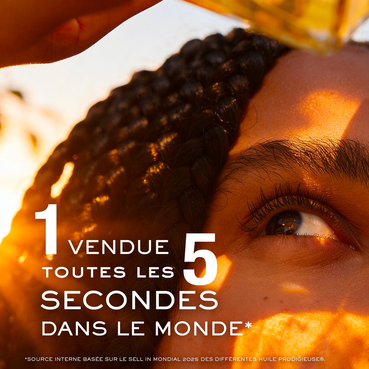 NUXE Huile Prodigieuse Gold, woman with braids in golden light, text in French