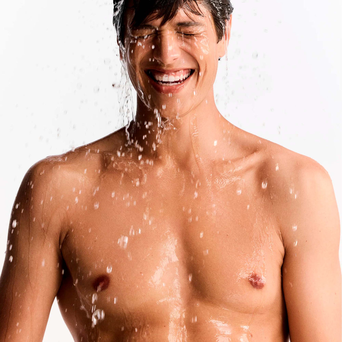 NUXE Men Boost, smiling man under splashing water