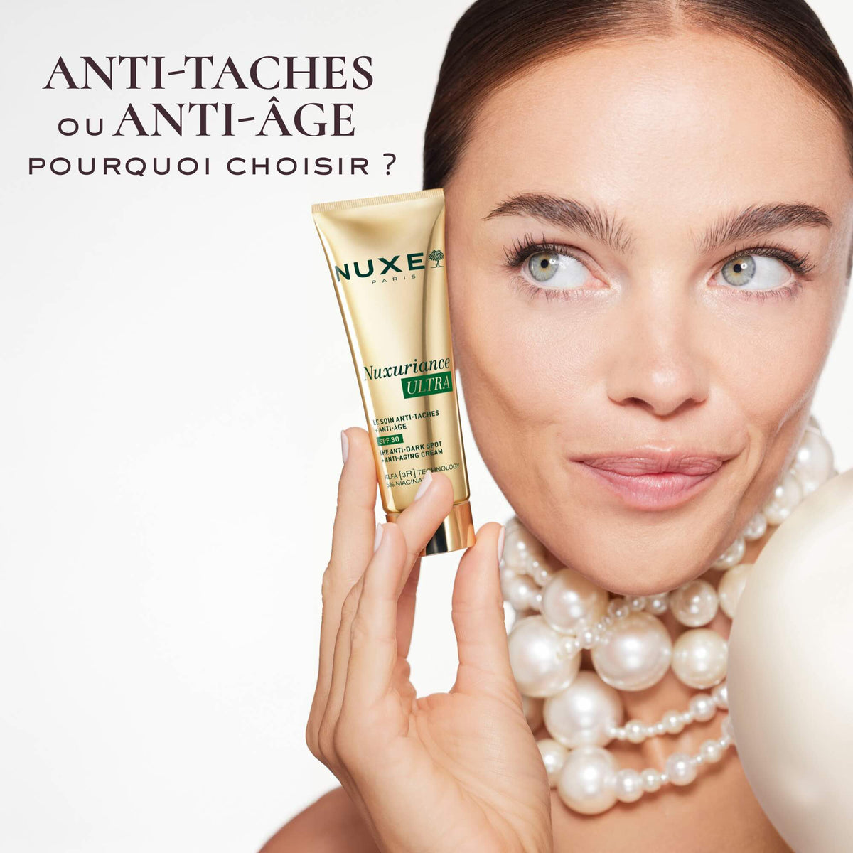 NUXE Nuxuriance Ultra, woman in pearls holding the tube, text in French