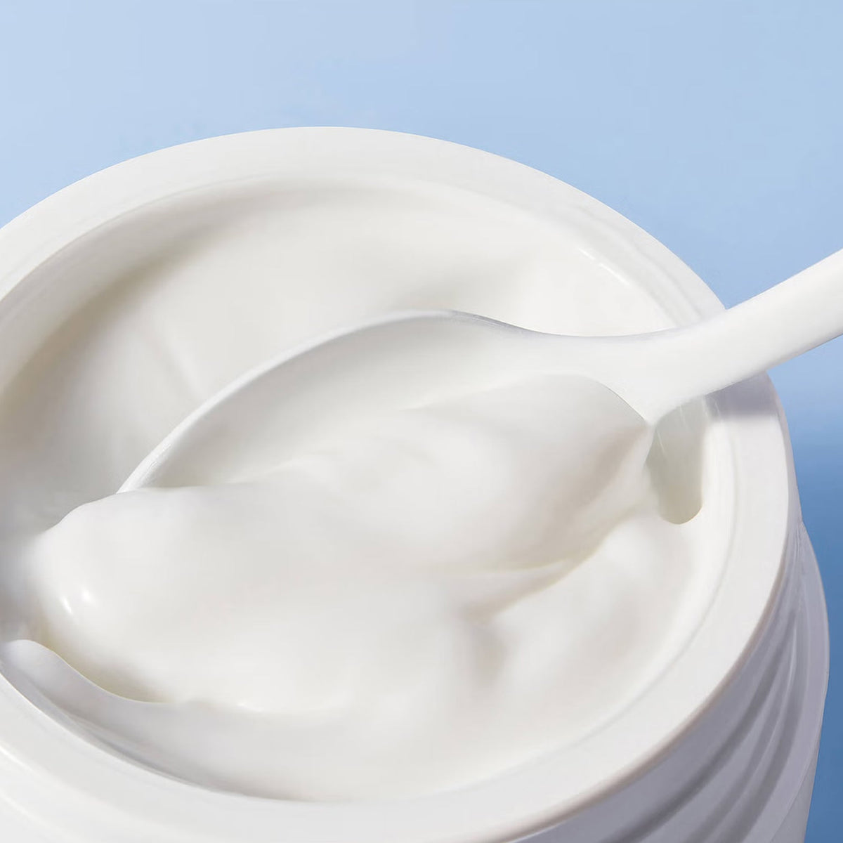 NUXE Crème Fraîche de Beauté, open jar with a spatula of cream