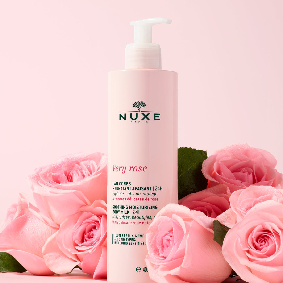 NUXE Very Rose, pump bottle among pink roses