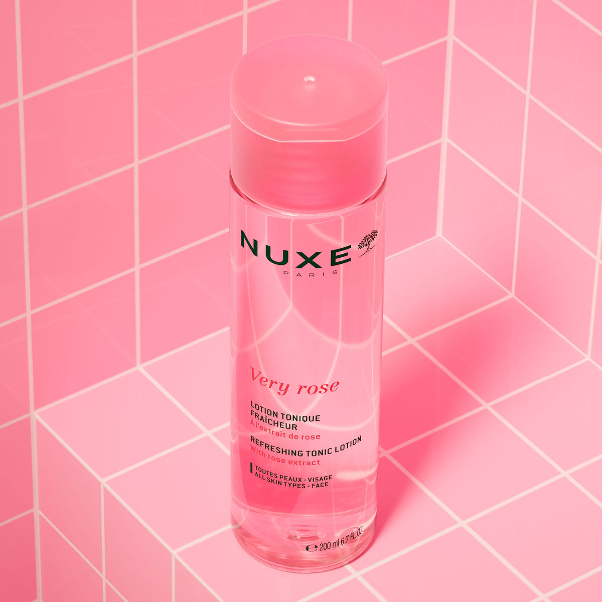 NUXE Very Rose, bottle standing on pink tiles