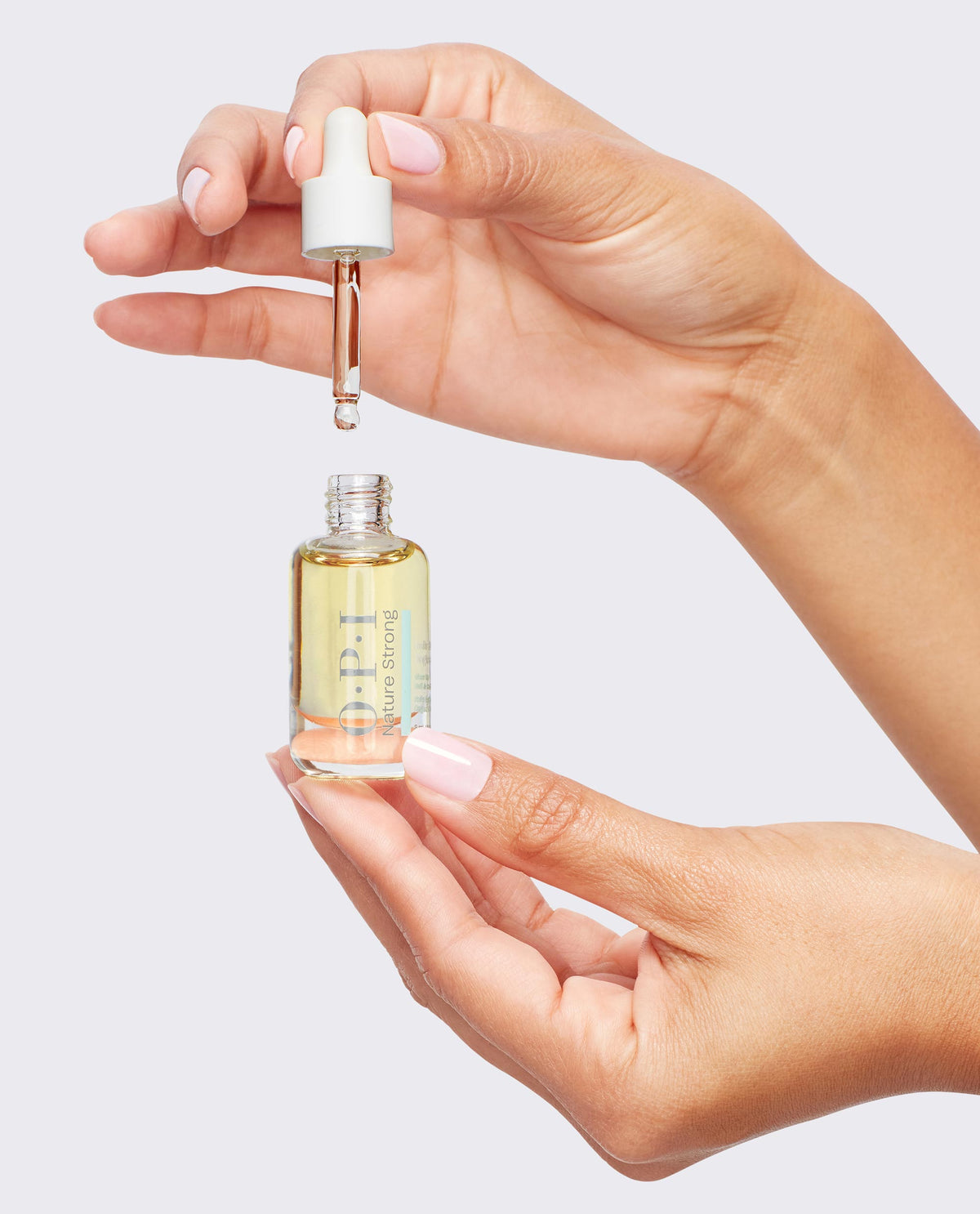 OPI Nature Strong, open dropper bottle held in one hand, dropper in the other