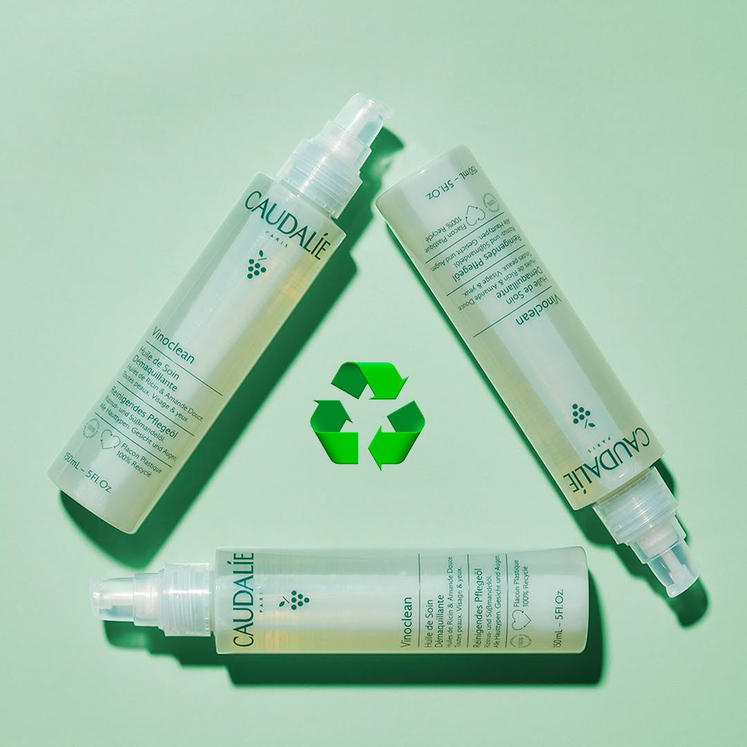 Caudalie skincare products on a light green background with a recycling symbol.