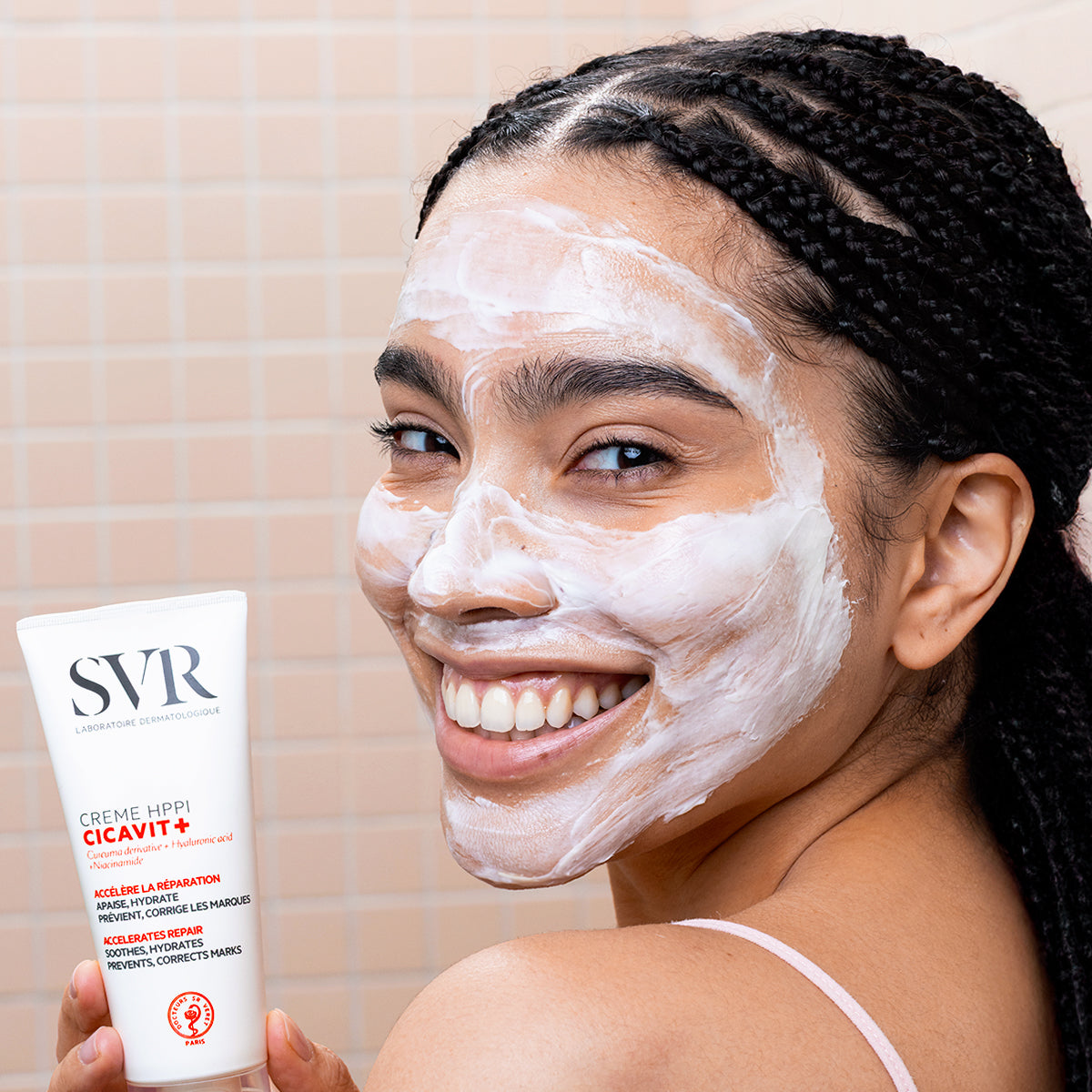 SVR Cicavit+, smiling woman with the cream spread on her face, holding the tube