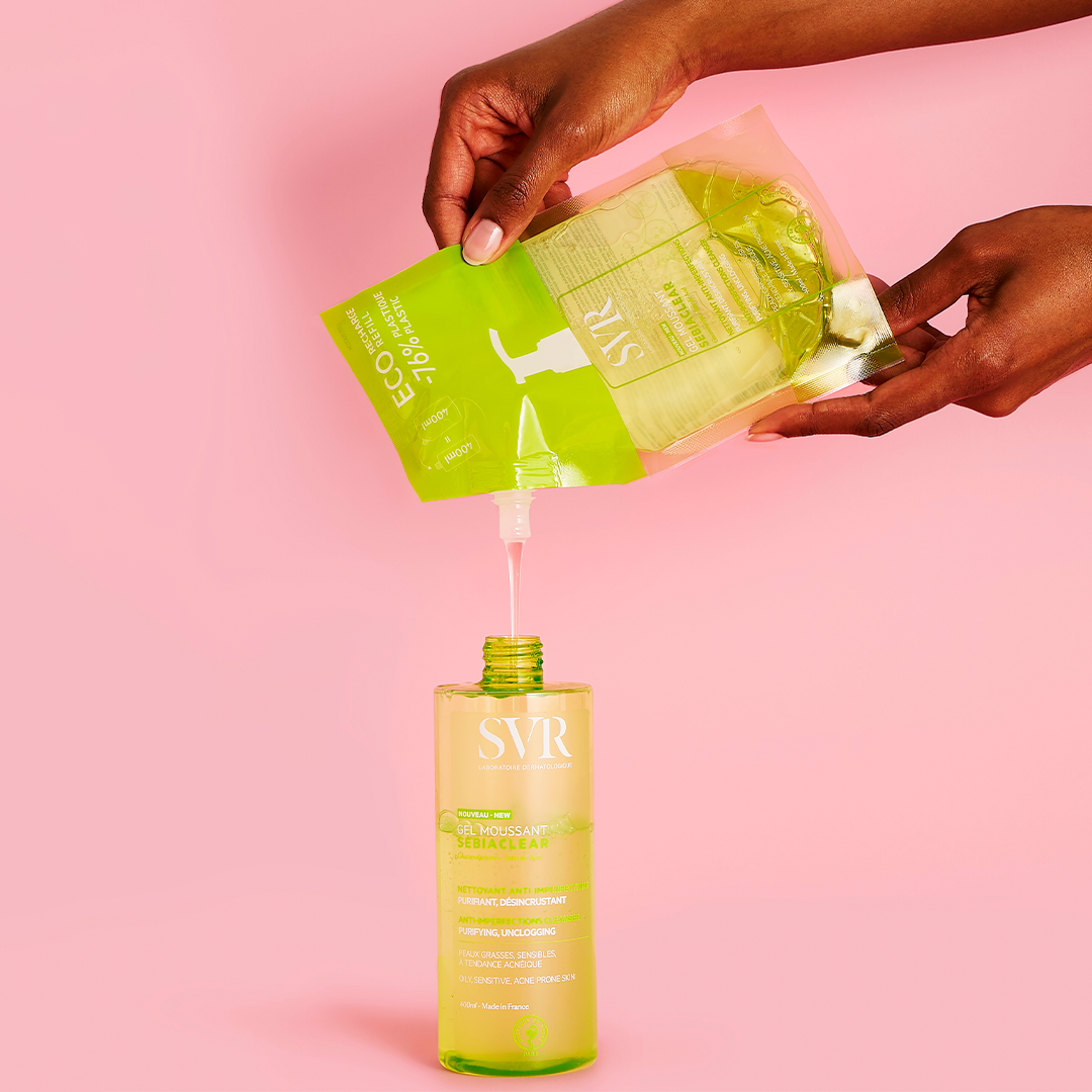 SVR Sebiaclear, hands pouring the refill pouch into the bottle