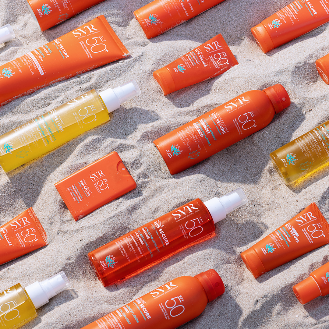 SVR Sun Secure, range of sun care products scattered on sand