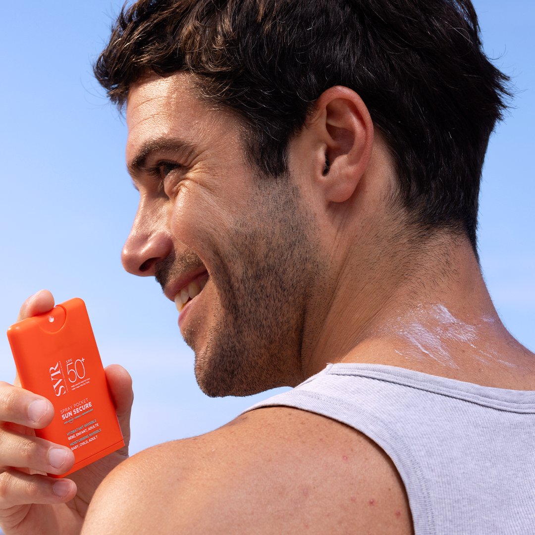 SVR Sun Secure, smiling man in a tank top holding the pocket spray
