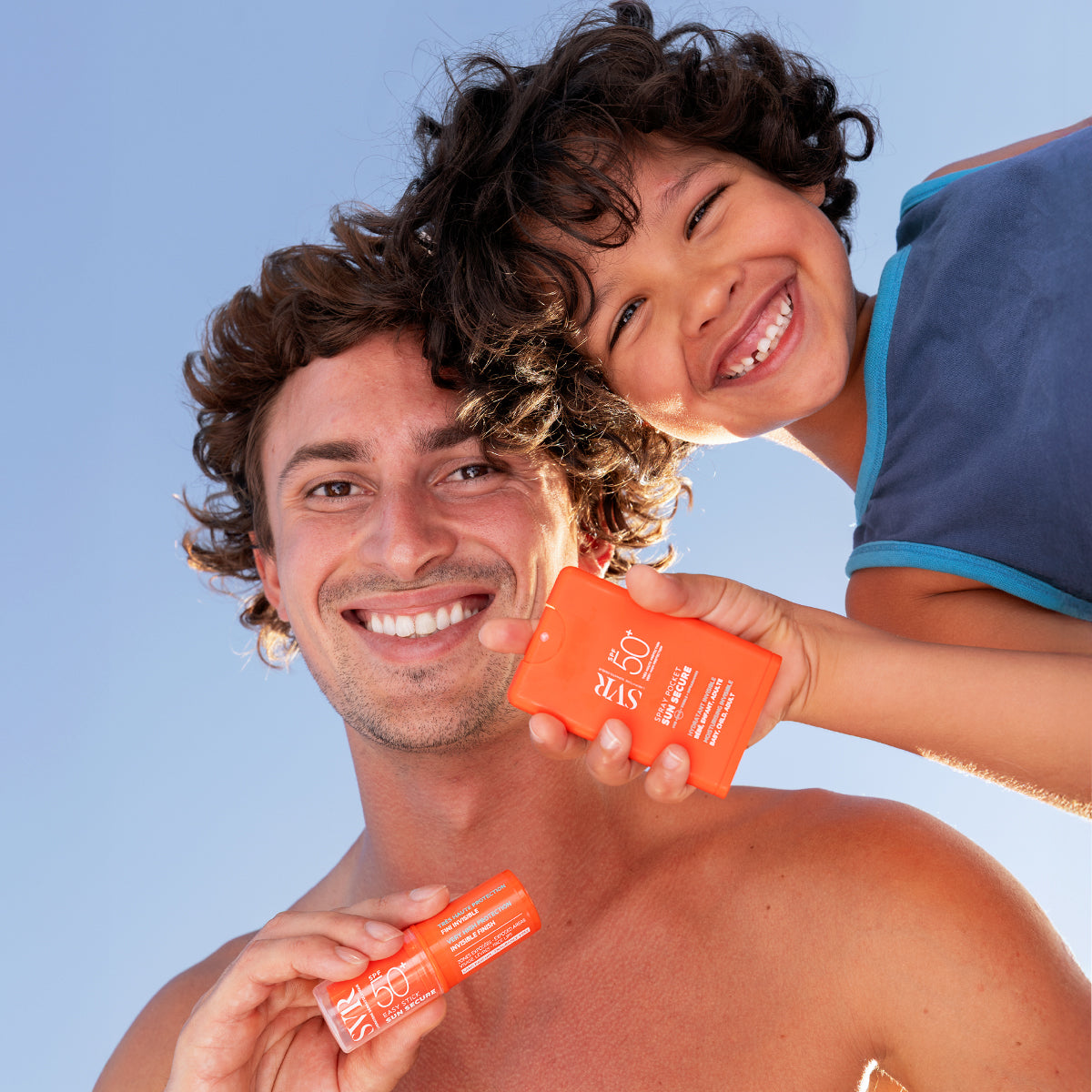SVR Sun Secure, smiling man and boy holding the pocket spray