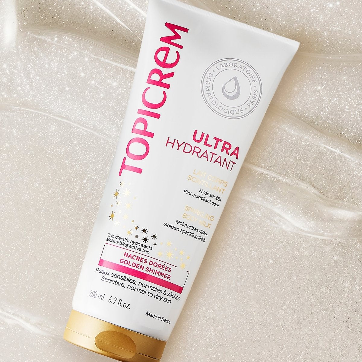 Topicrem Ultra Hydratant 200ml, tube on a bed of shimmering milk