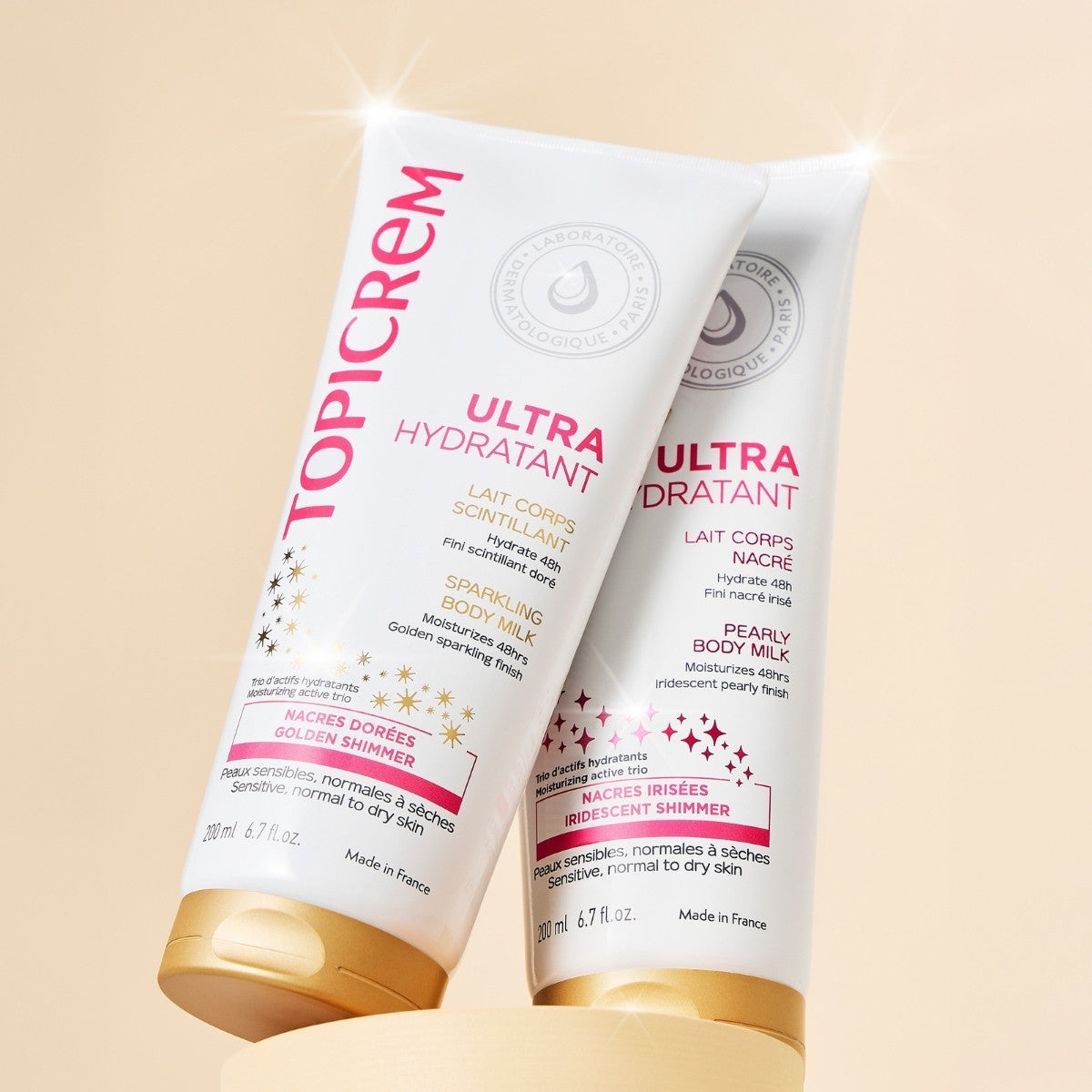 Topicrem Ultra Hydratant, sparkling and pearly body milk tubes side by side