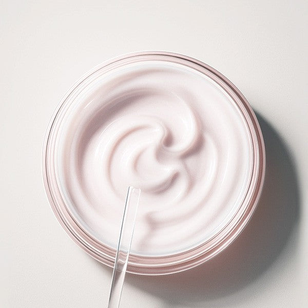 Uriage Age Absolu, open jar of pink balm with a spatula, top view