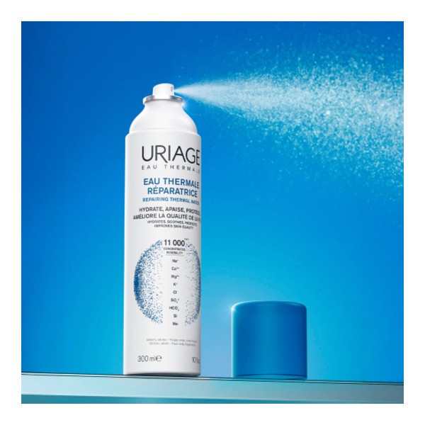 Uriage Thermal Water 300ml, spray can misting on a blue background