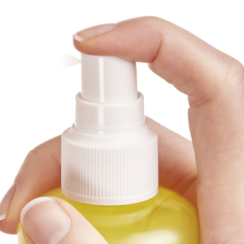 Vichy Capital Soleil, finger pressing the spray pump, close-up