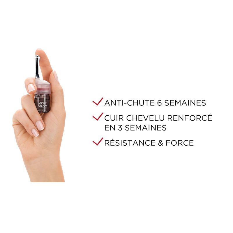 Vichy Dercos Aminexil, hand holding a vial with benefits in French