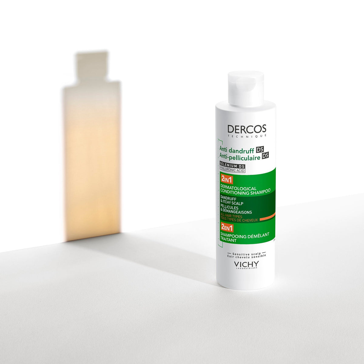 Vichy Dercos DS, bottle with a glowing amber silhouette behind