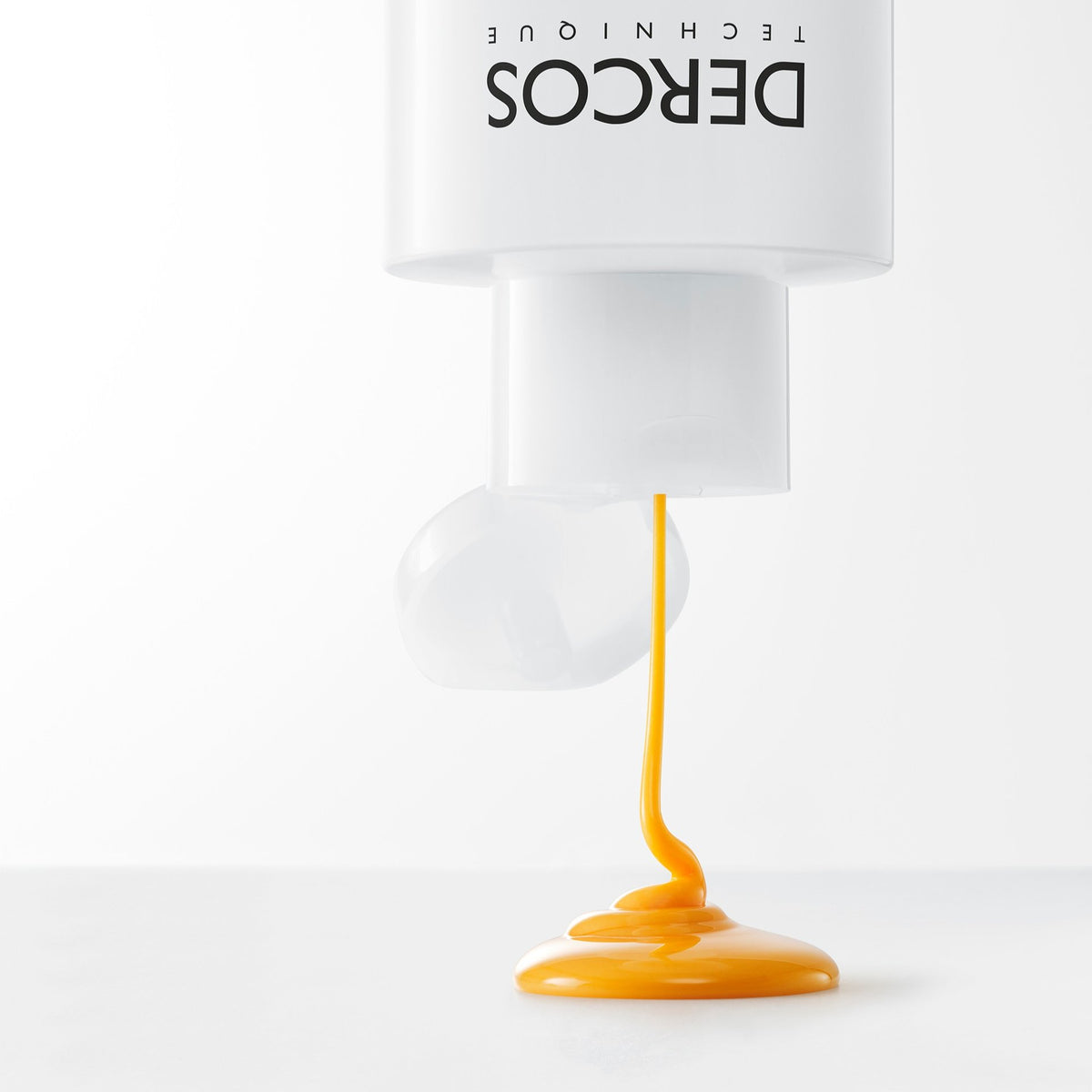 Vichy Dercos DS, orange shampoo pouring from the bottle