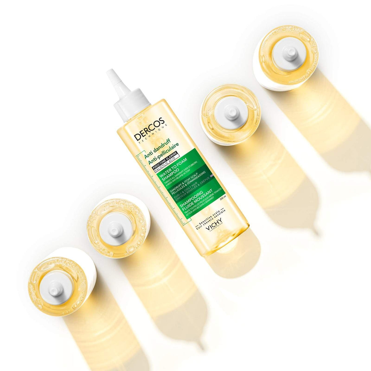 Vichy Dercos, top view of bottles casting golden shadows