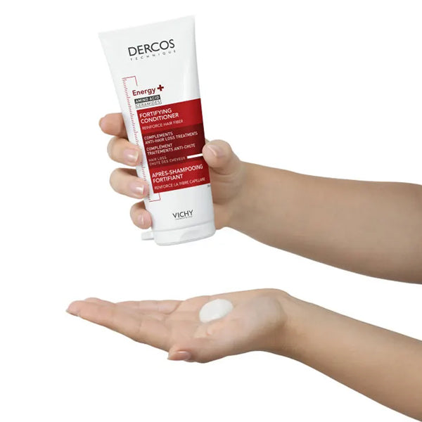 Vichy Dercos Energy+, hand holding the tube above cream in a palm