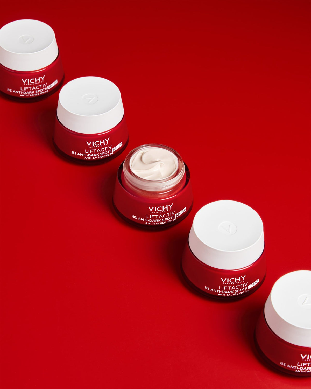 Vichy Liftactiv B3, row of jars on a red background, one open
