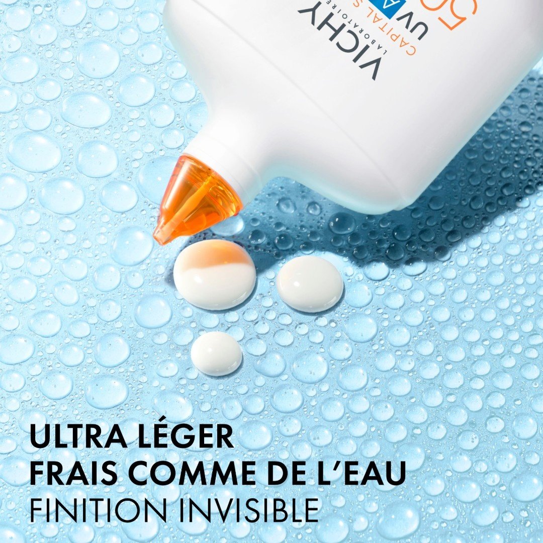 Vichy UV-Aqua, fluid drops from the bottle tip on a wet surface, text in French