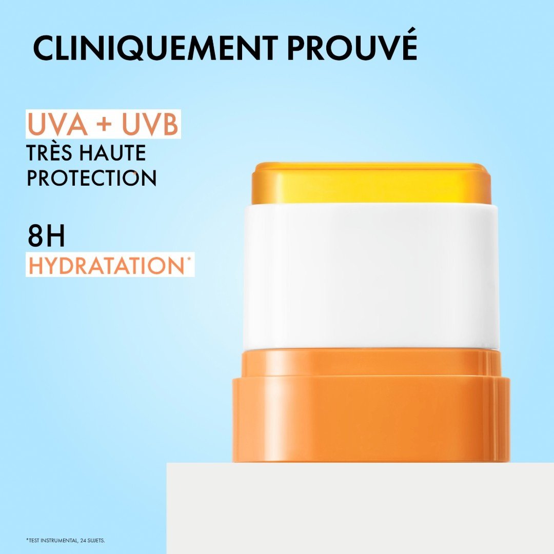 Vichy UV Aqua, uncapped stick on a blue background with text in French