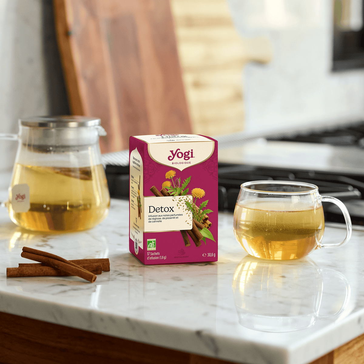 Yogi Tea Detox, box on a marble counter with a teapot and a cup of infusion
