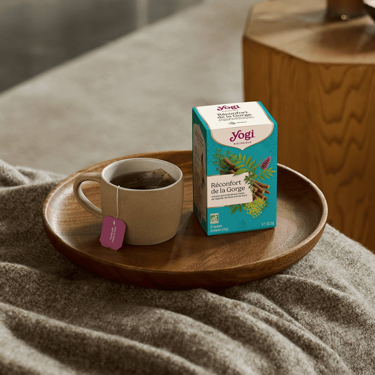 Yogi Tea Throat Comfort, box on a wooden tray with a mug of infusion